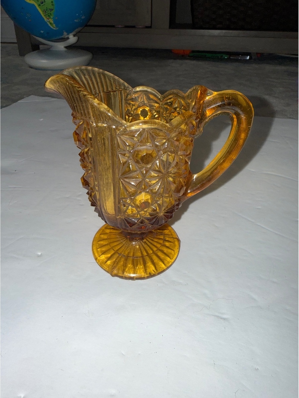 Amber Pressed Glass Creamer Pitcher with Starburst Pattern